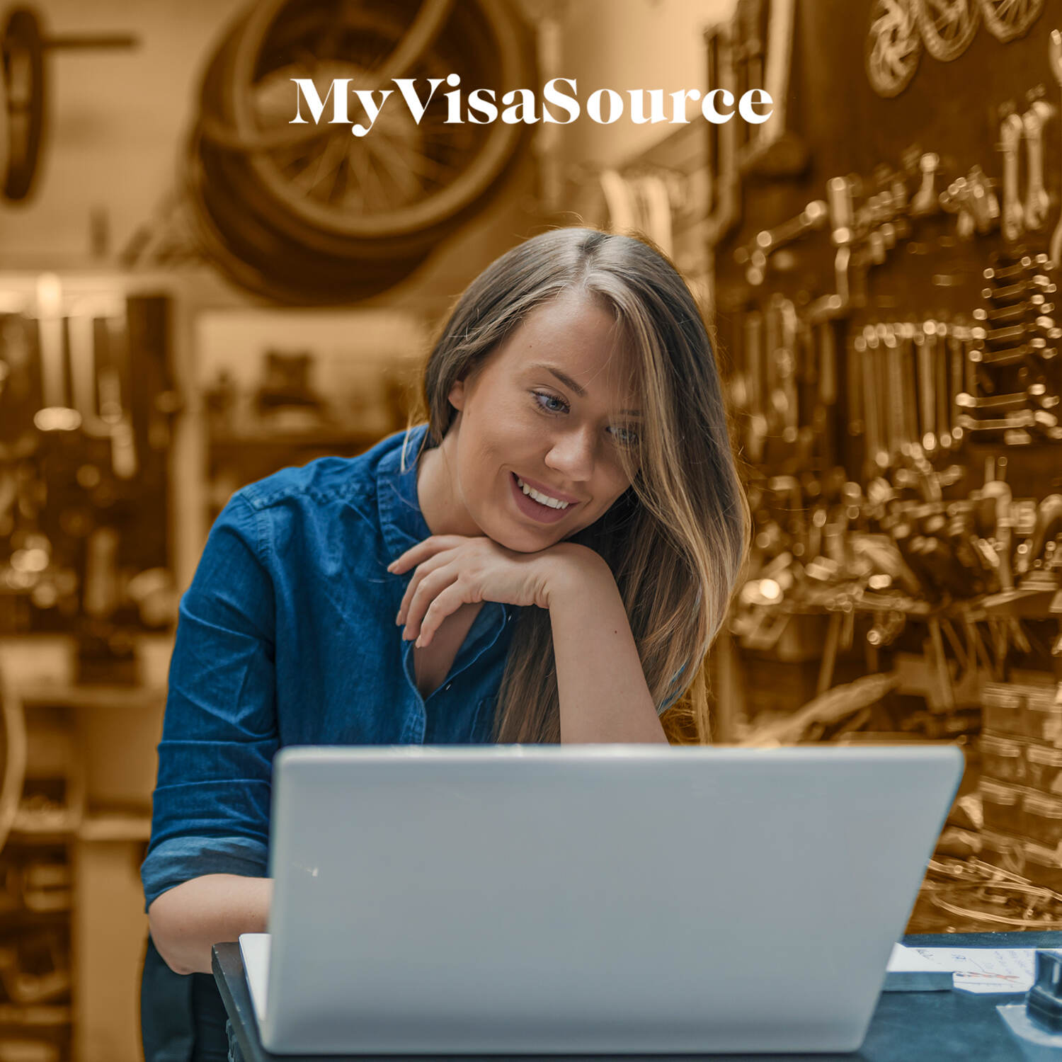 bicycle shop owner working in front of laptop my visa source