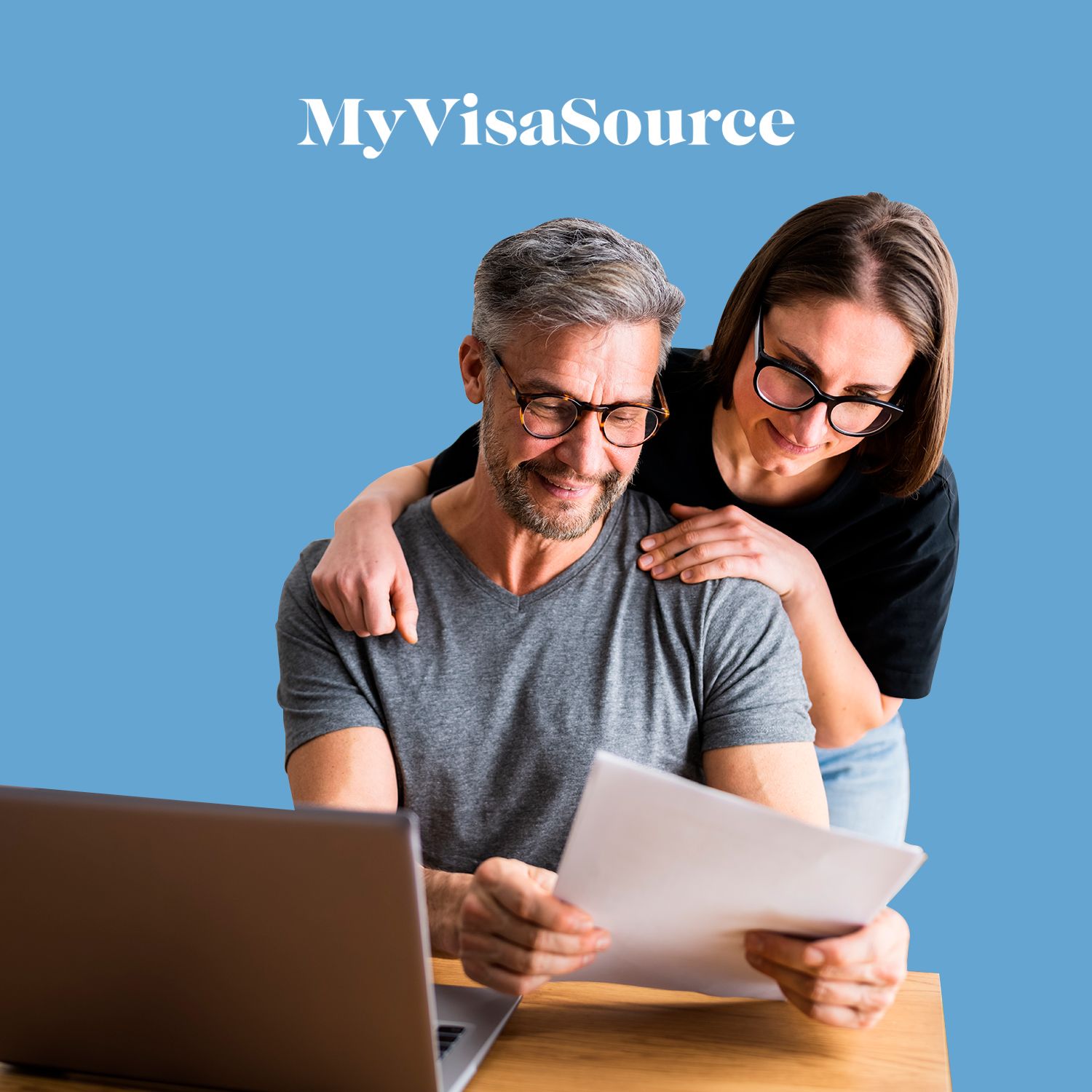 couple looking over documents and laptop my visa source