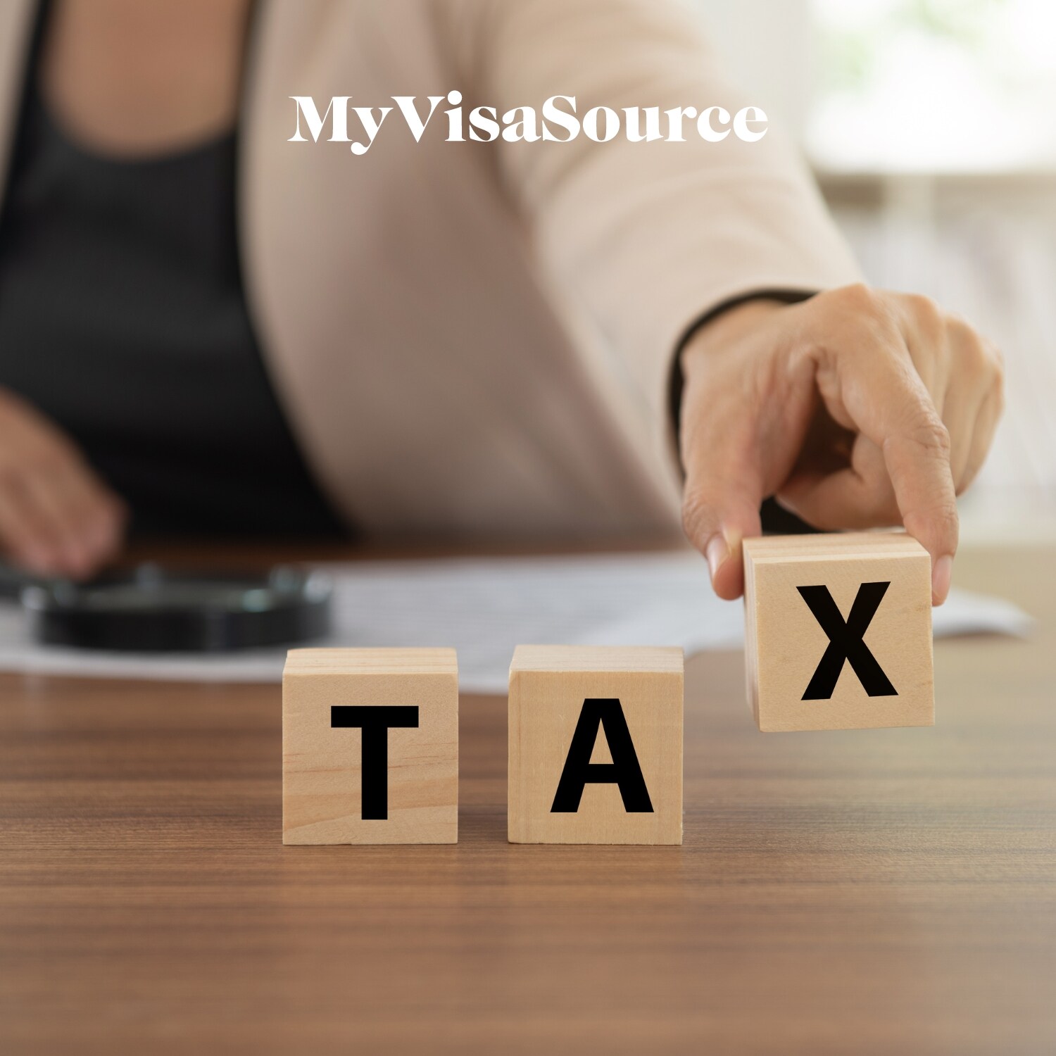 woman holding wodden tiles and showing the word tax - 200kb