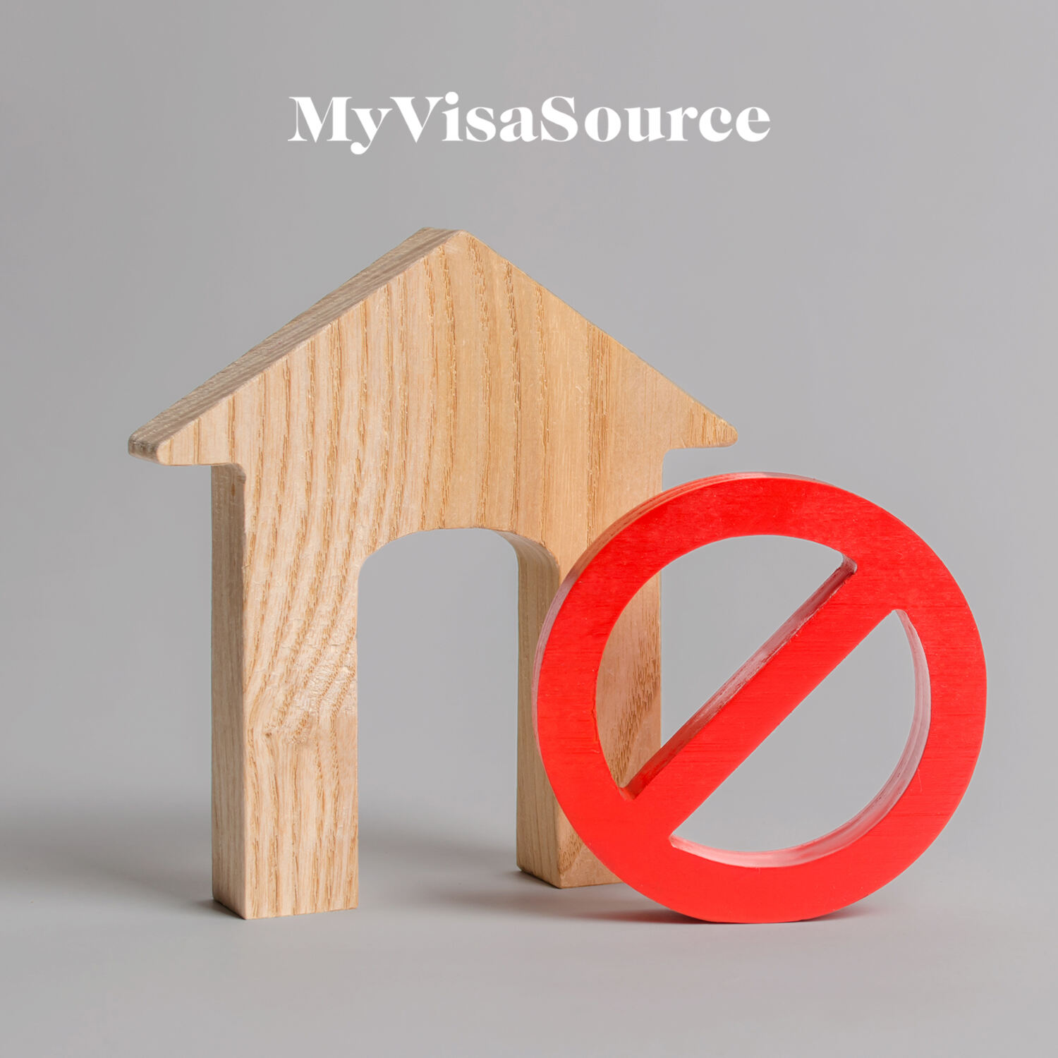 wooden house cutout with a red no symbol beside it