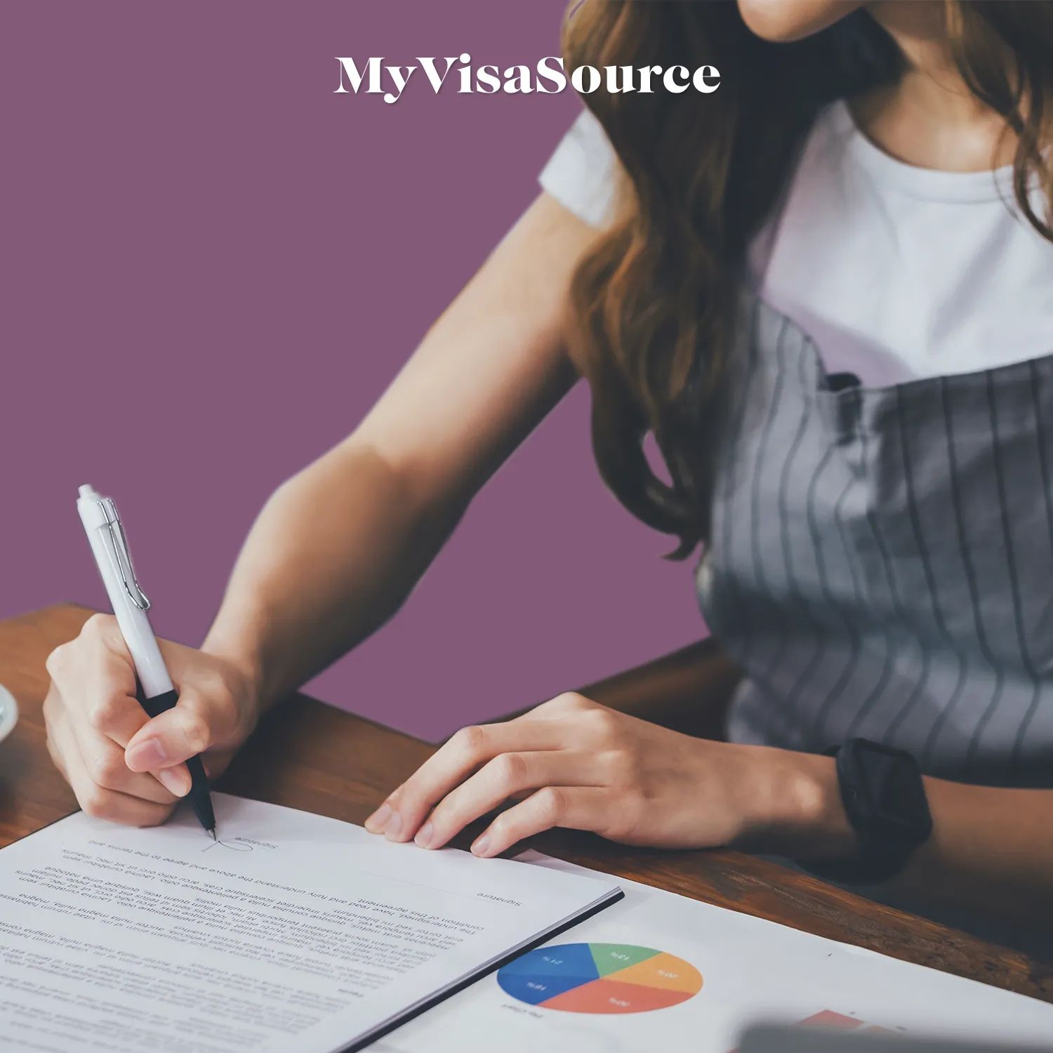 a-woman-signing-paperwork-by-my-visa-source