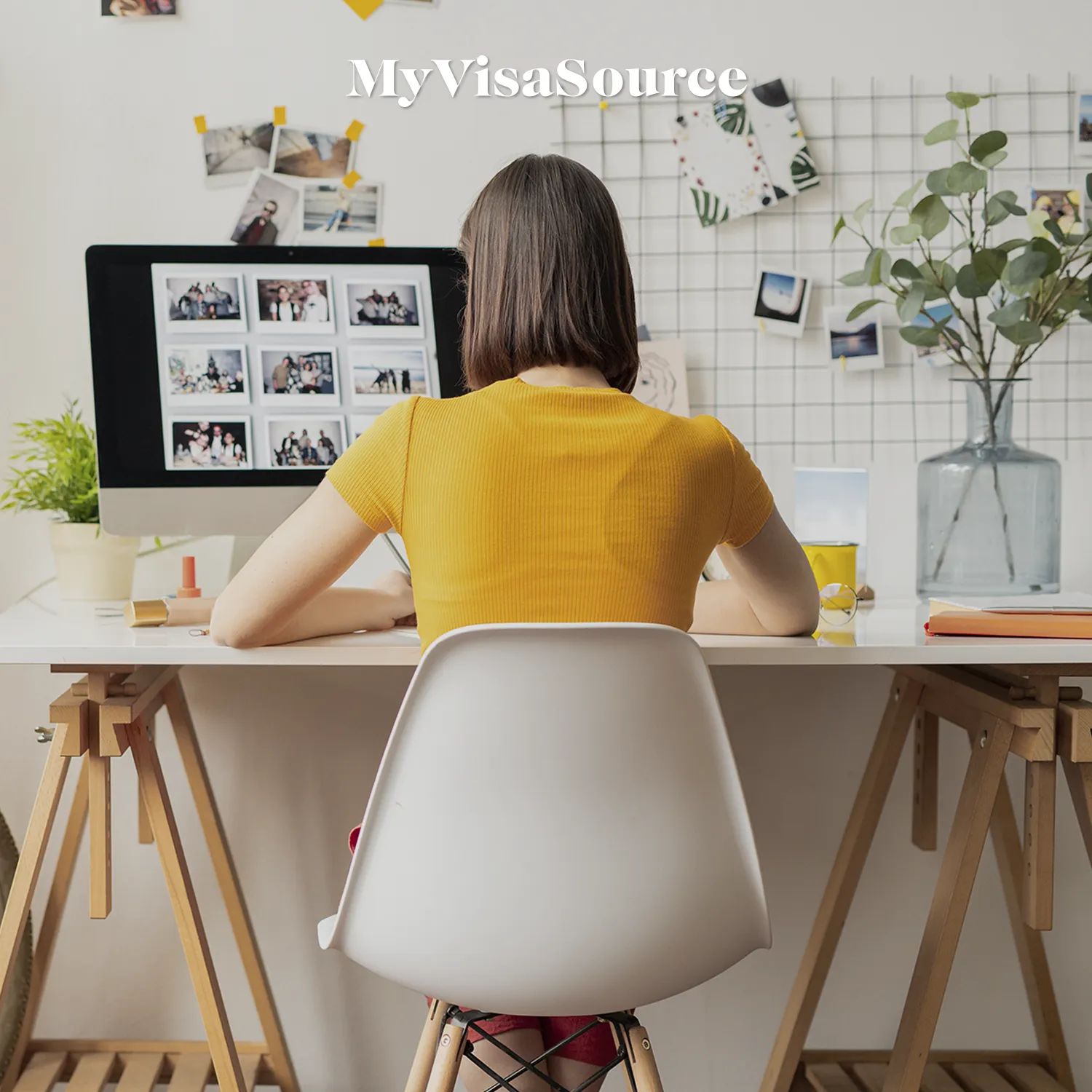 a-woman-working-at-her-desk-by-my-visa-source