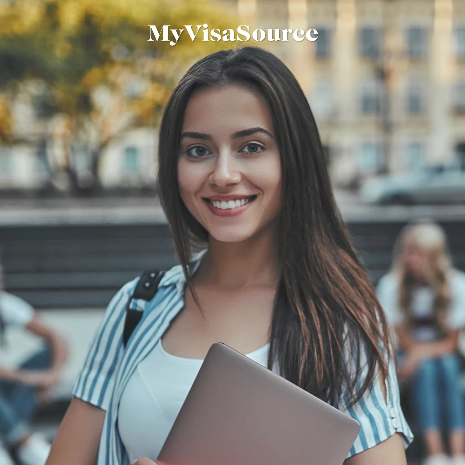 a-young-woman-holding-a-laptop-by-my-visa-source