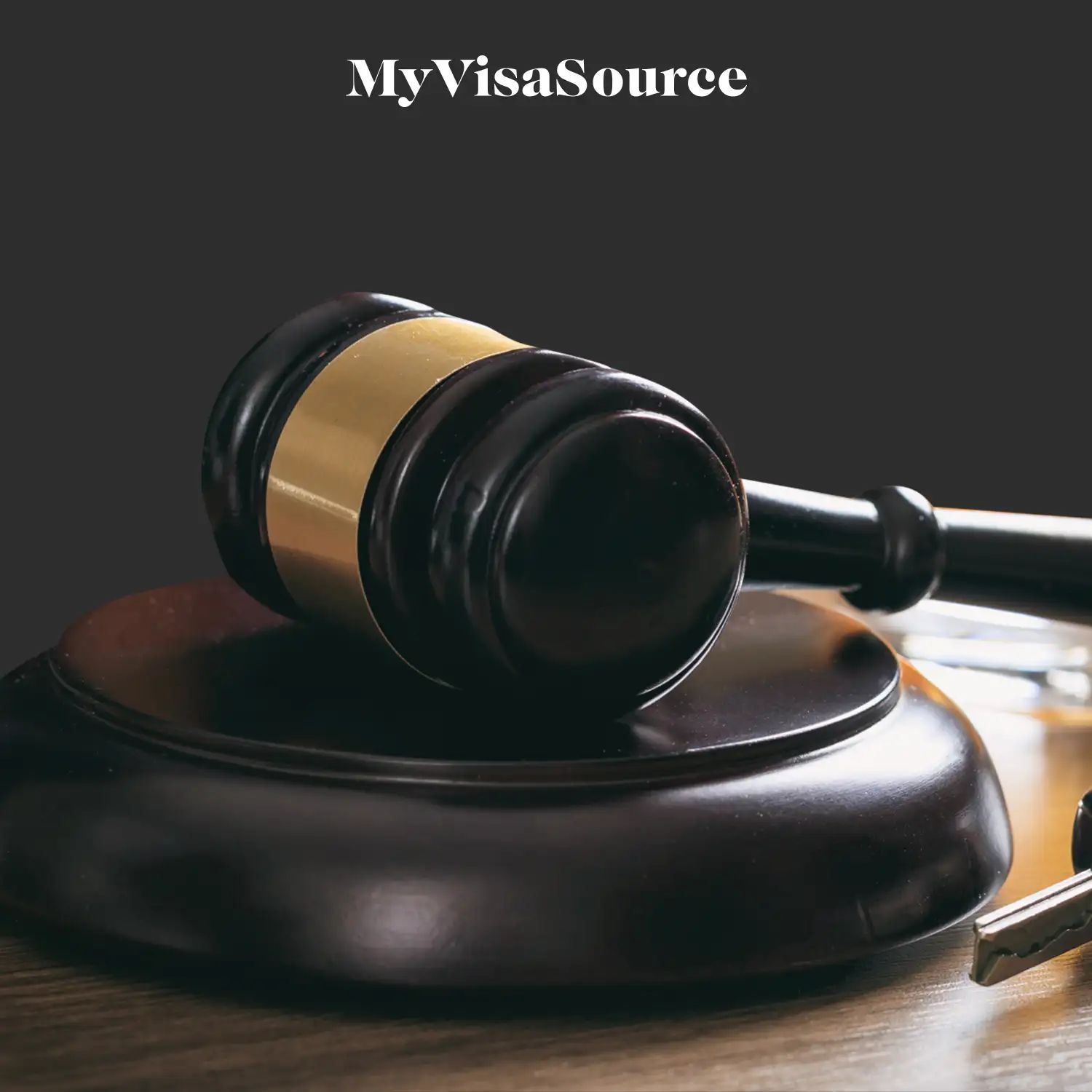 gavel on a stand on dark brown background by my visa source