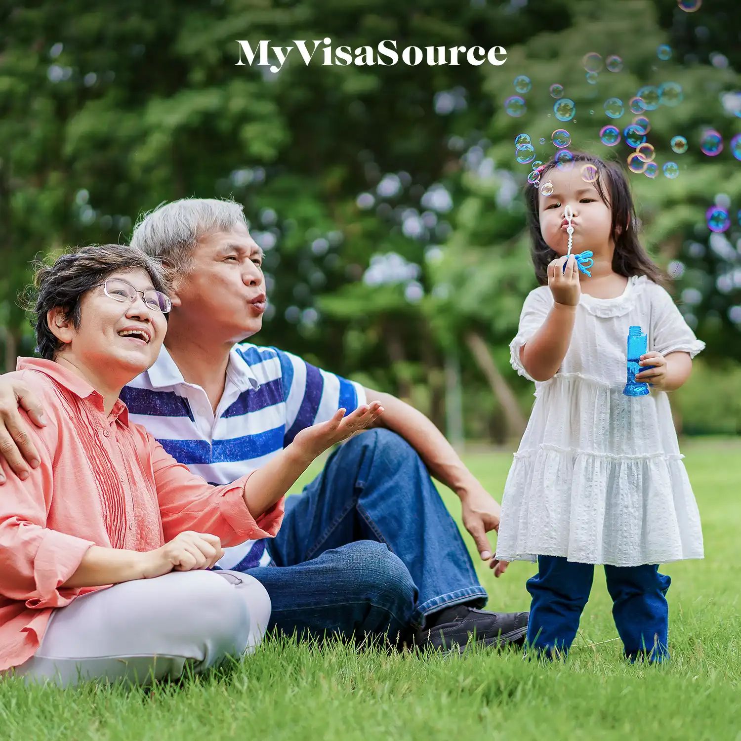 grandparents-enjoying-their-granddaughter-blowing-water-balloons-relaxing-on-the-grass-by-my-visa-source