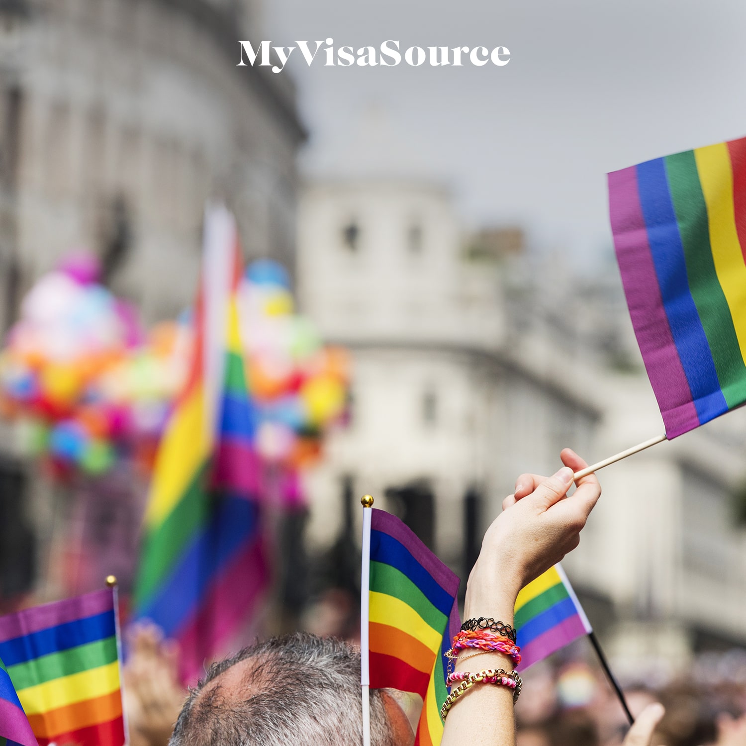 mini-rainbow-flags-waved-at-a-parade-my-visa-source-min